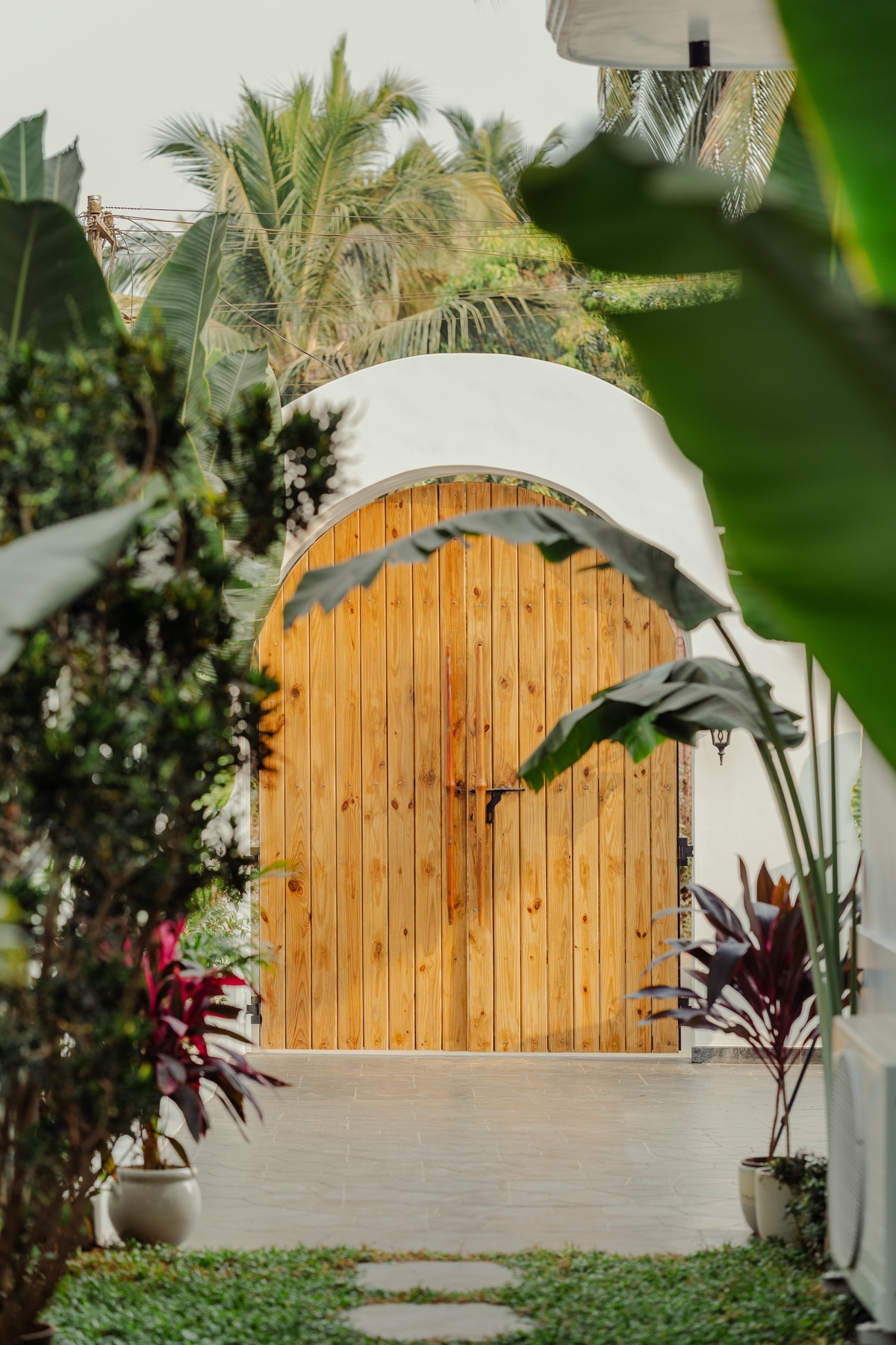 Hand-painted palm mural on a white villa wall